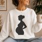 Minimalist side-view silhouette of an expectant mother with a large baby bump, smooth flowing contours and a clean solid black silhouette for craft projects.